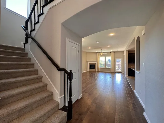 a view of entryway and hall with wooden floor