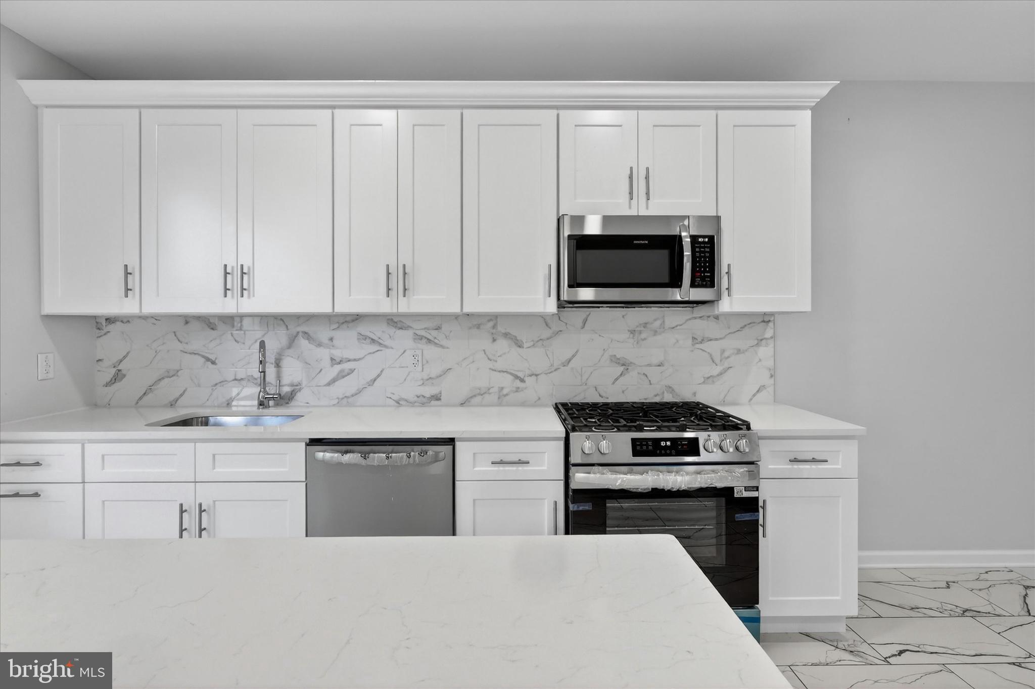509 Lumberton Road, Unit 1 Hainesport, NJ 08036 - Photo 17 of 33 a kitchen with white cabinets and stainless steel appliances