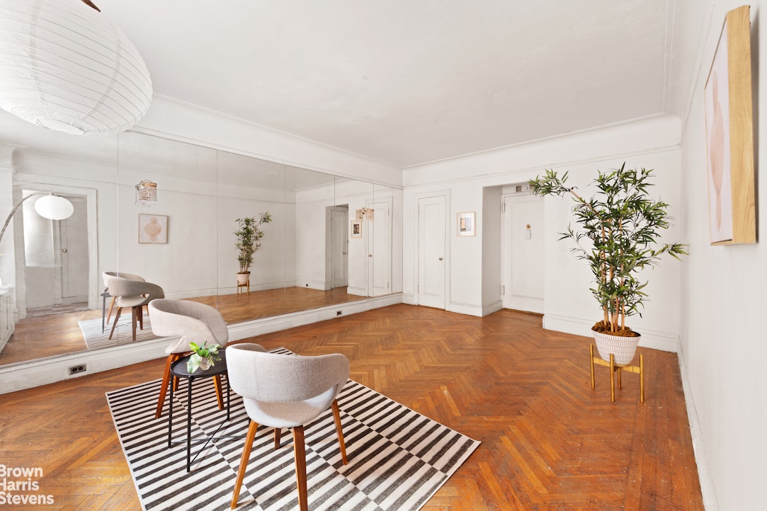 a living room with furniture and a potted plant