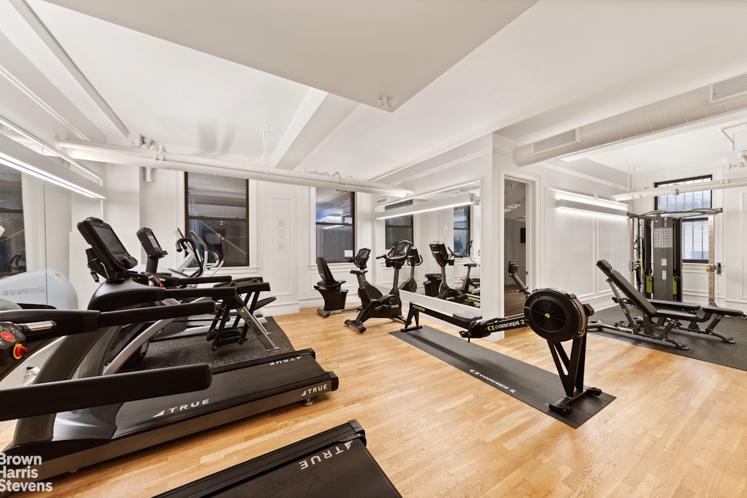 395 Riverside Drive, Unit 1E Manhattan, NY 10025 - Photo 6 of 7 a living room with gym equipment