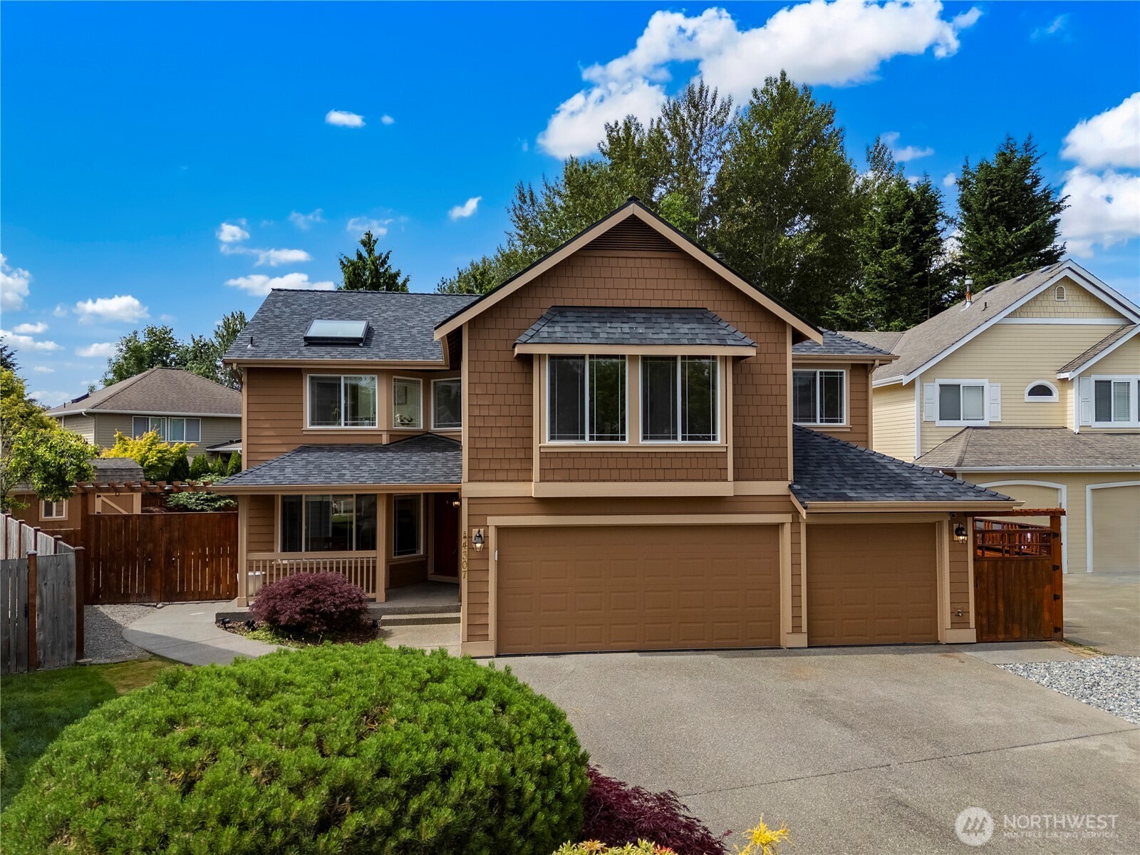 4307 Northeast 7th Place Renton, WA 98059 - Photo 3 of 39 a front view of a house with a garden
