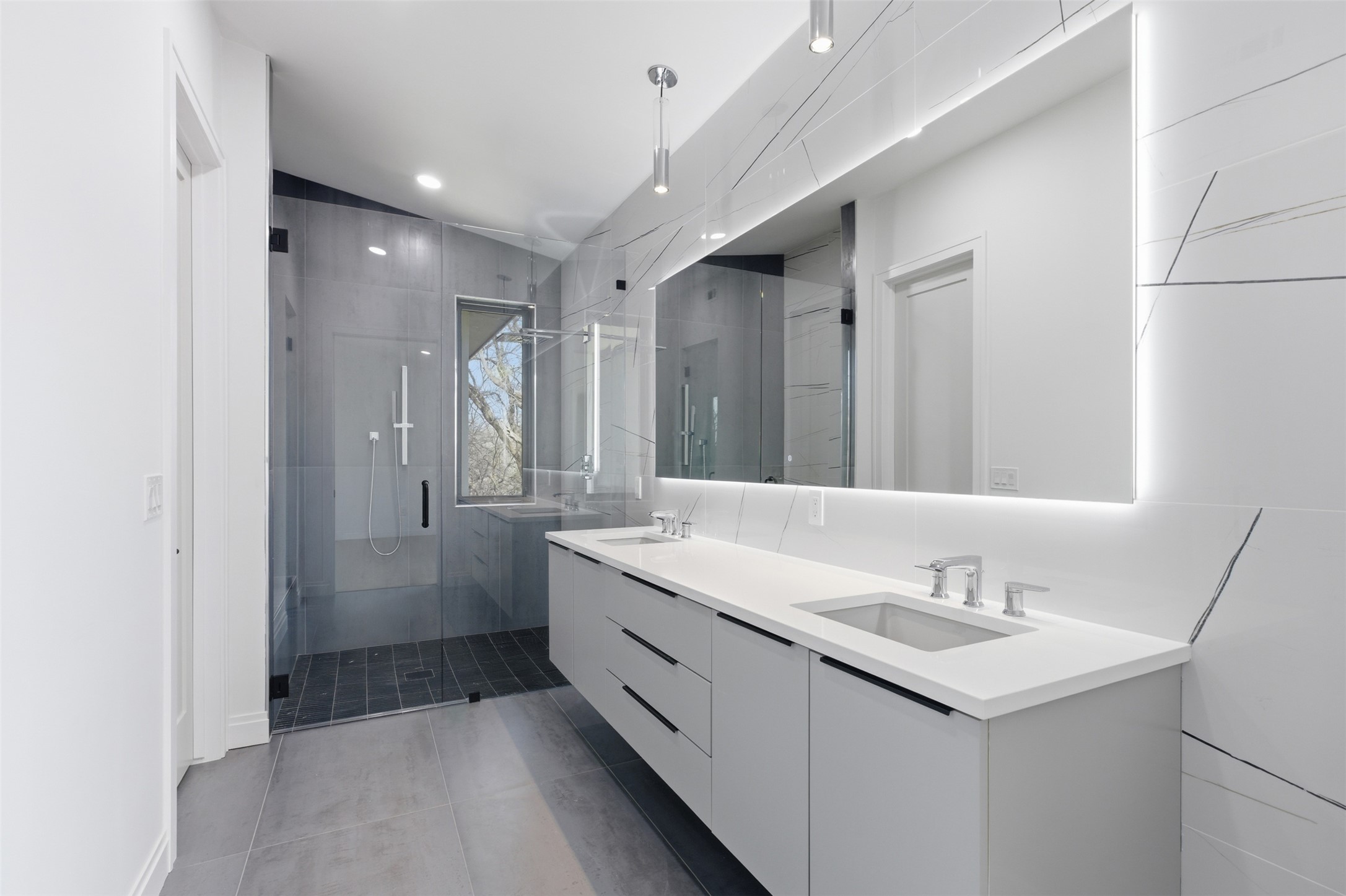 5013 Rob-Scott Street Austin, TX 78721 - Photo 17 of 35 Primary Bathroom with a floating vanity and LED mirror.