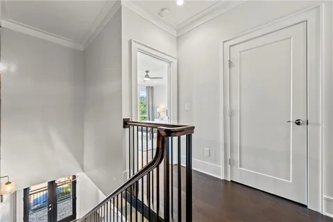 a view of a hallway with wooden floor and entryway