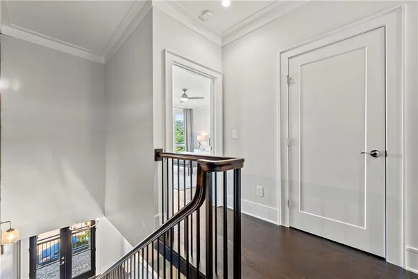a view of a hallway with wooden floor and entryway