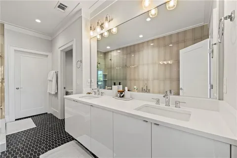 a bathroom with a sink double vanity and a mirror