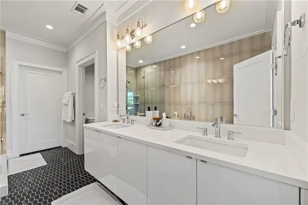 a bathroom with a sink double vanity and a mirror