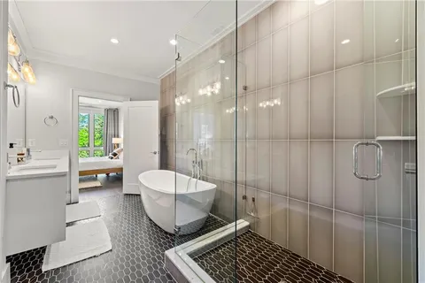 a bathroom with a sink a toilet a mirror and shower