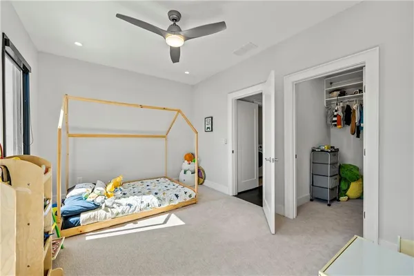 a bedroom with bed and a chandelier