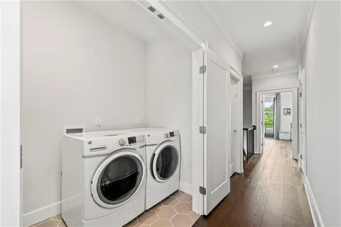 a view of a hallway with washer and dryer