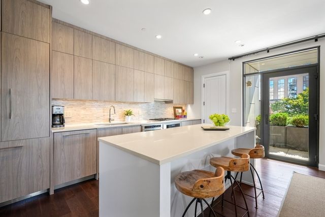 a kitchen with a table chairs and a refrigerator
