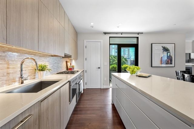 a kitchen with sink a stove and cabinets