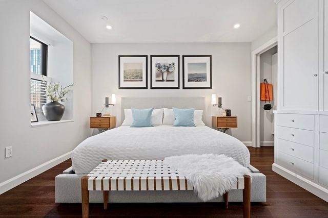 a bedroom with a large bed and a chandelier