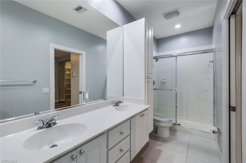 3462 Bravada Way Naples, FL 34119 - Photo 18 of 35 a bathroom with a double vanity sink mirror and shower