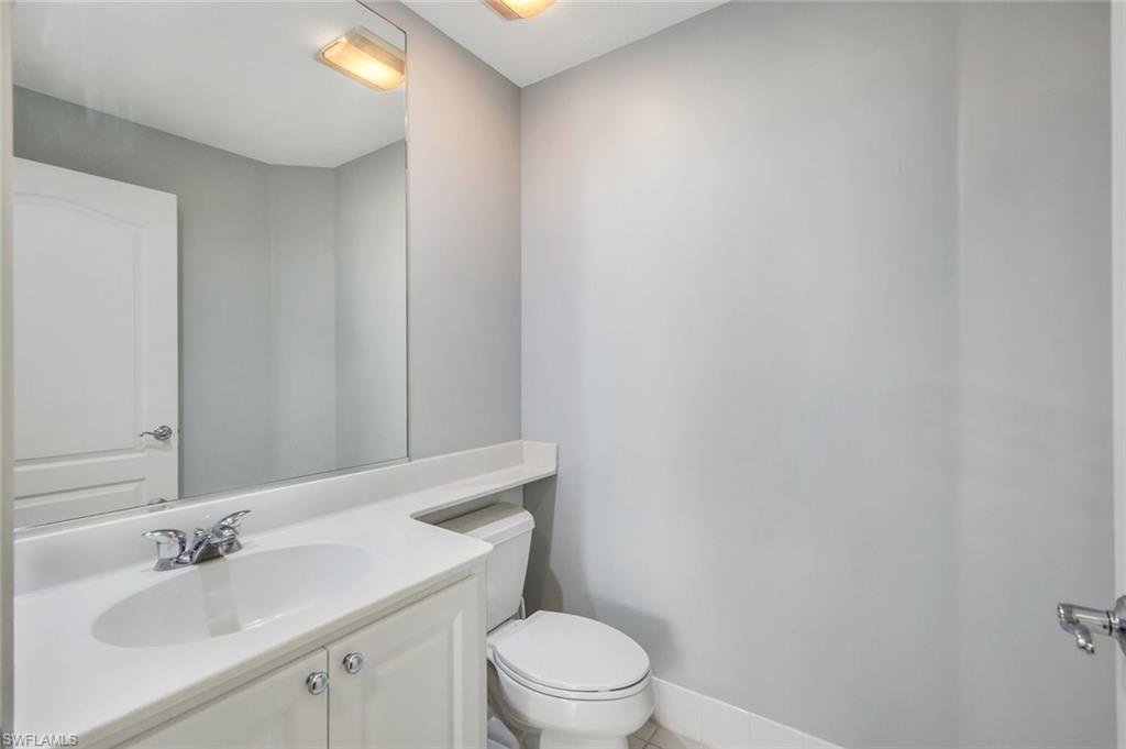 3462 Bravada Way Naples, FL 34119 - Photo 22 of 35 a bathroom with a sink a toilet and mirror