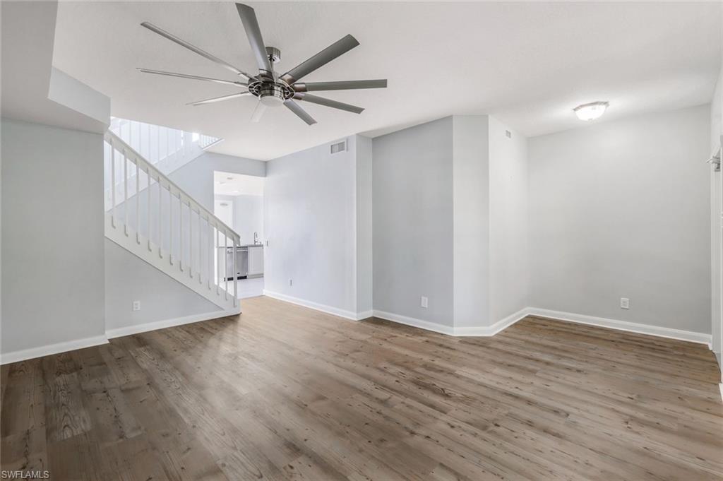 3462 Bravada Way Naples, FL 34119 - Photo 4 of 35 a view of a room with wooden floor and a ceiling fan