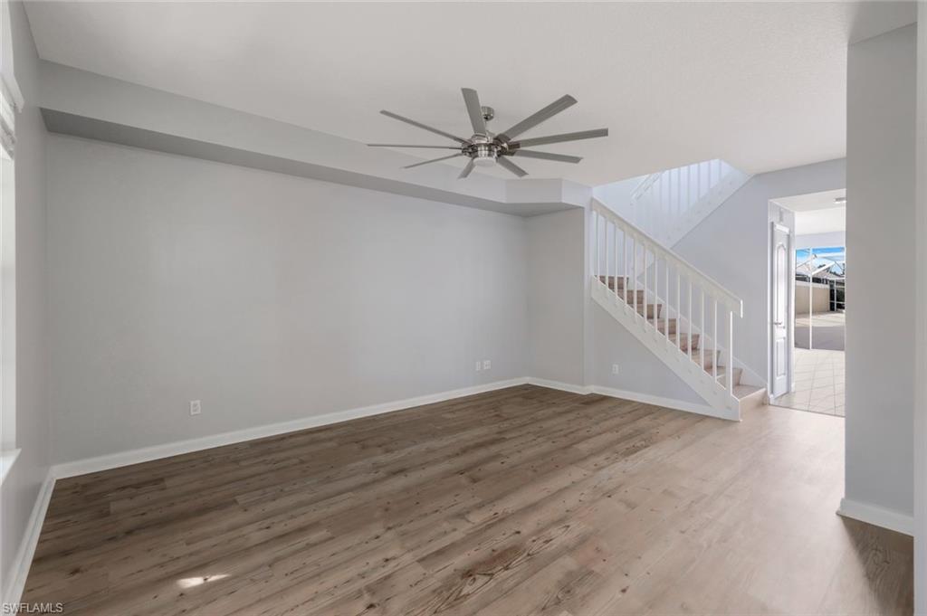 3462 Bravada Way Naples, FL 34119 - Photo 5 of 35 a view of an empty room with a window and a chandelier fan