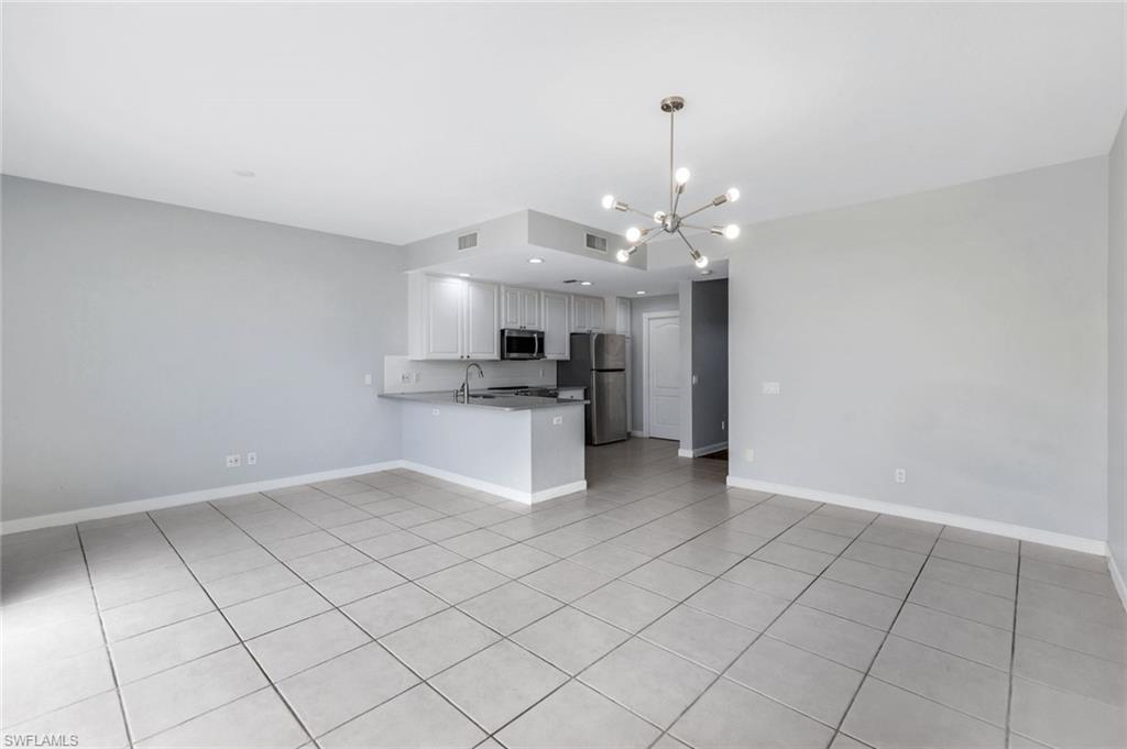 3462 Bravada Way Naples, FL 34119 - Photo 7 of 35 a view of a kitchen with microwave and cabinets