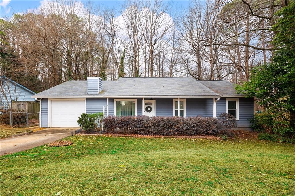 1572 Kings Ridge Drive Northwest Norcross, GA 30093 - Photo 1 of 20 a front view of house with yard and green space
