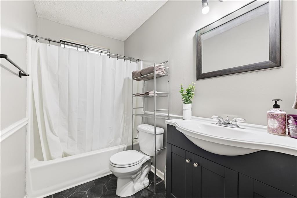 1572 Kings Ridge Drive Northwest Norcross, GA 30093 - Photo 11 of 20 a bathroom with a sink vanity mirror and toilet