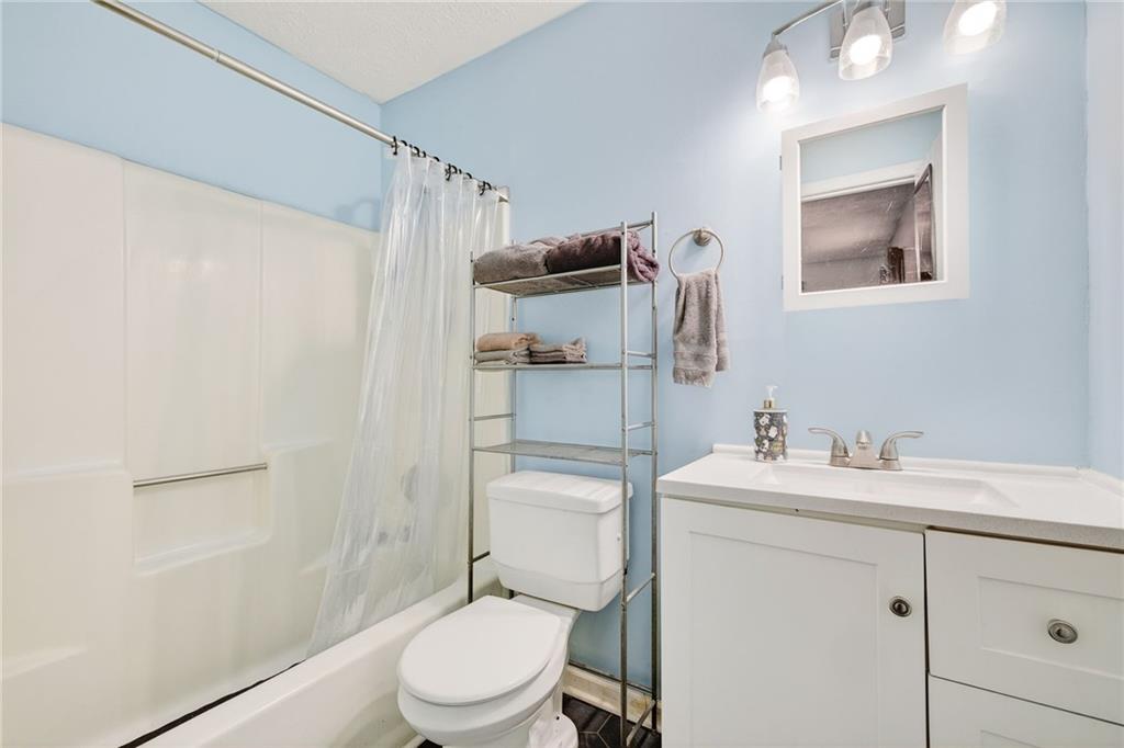 1572 Kings Ridge Drive Northwest Norcross, GA 30093 - Photo 15 of 20 a bathroom with a toilet sink vanity and mirror