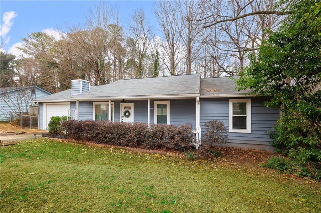 1572 Kings Ridge Drive Northwest Norcross, GA 30093 - Photo 2 of 20 a front view of house with yard and trees around