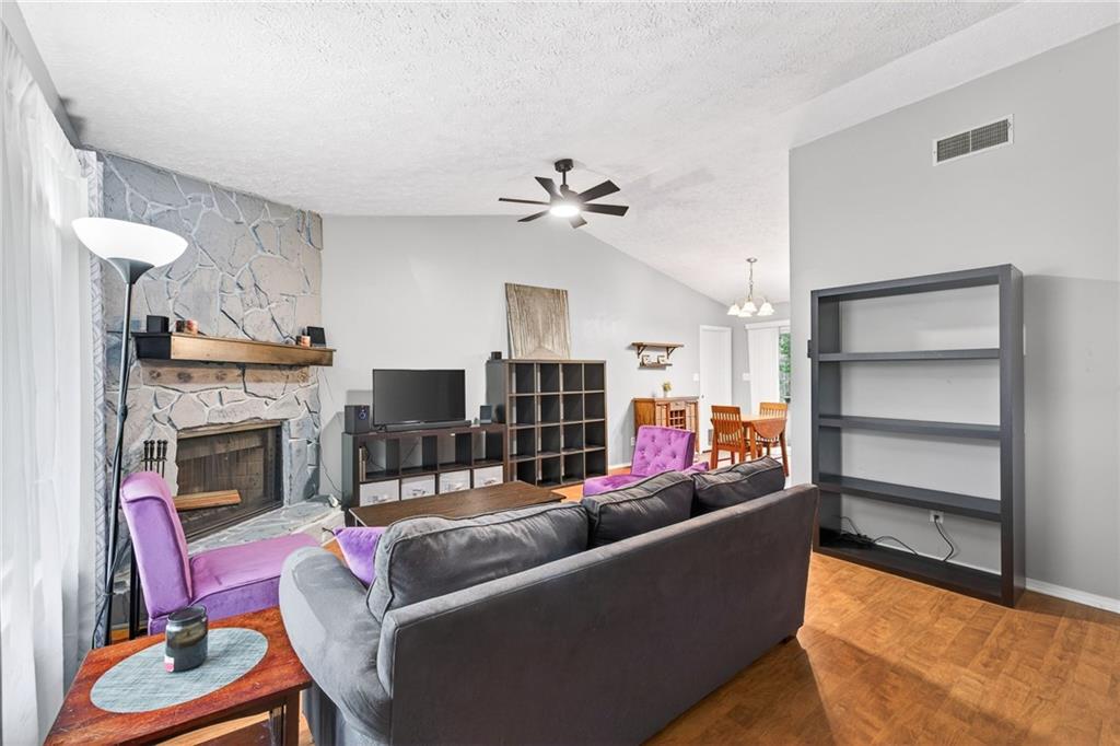 1572 Kings Ridge Drive Northwest Norcross, GA 30093 - Photo 4 of 20 a living room with furniture and a fireplace