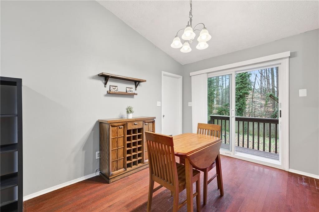 1572 Kings Ridge Drive Northwest Norcross, GA 30093 - Photo 9 of 20 a view of a dining room with furniture window and wooden floor