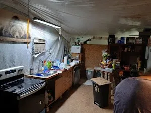 a kitchen with stainless steel appliances kitchen island granite countertop a stove and a refrigerator