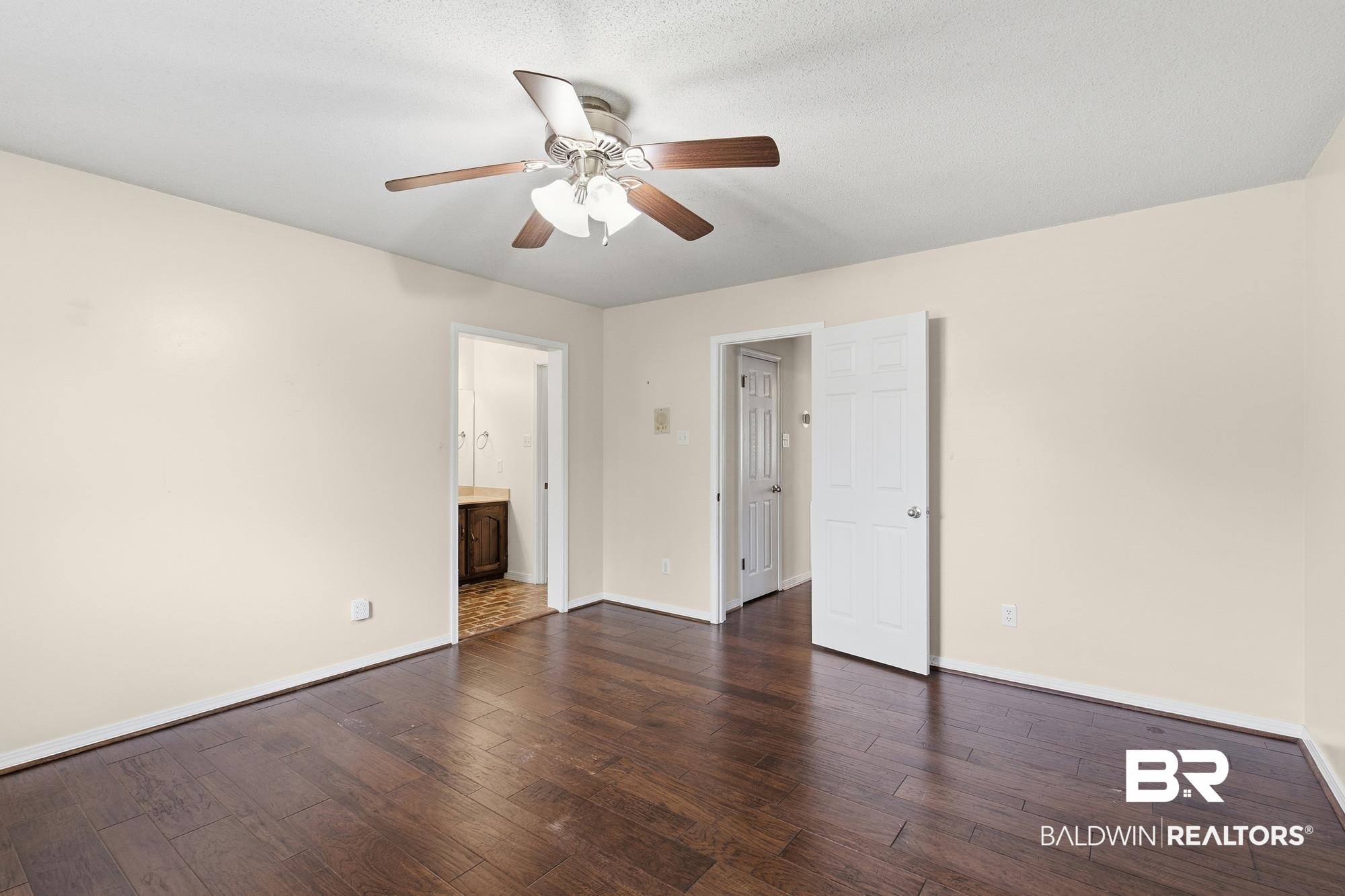 9215 Shiloh Drive Mobile, AL 36695 - Photo 27 of 32 Unfurnished bedroom featuring dark wood-type flooring, a ceiling fan, and ensuite bath