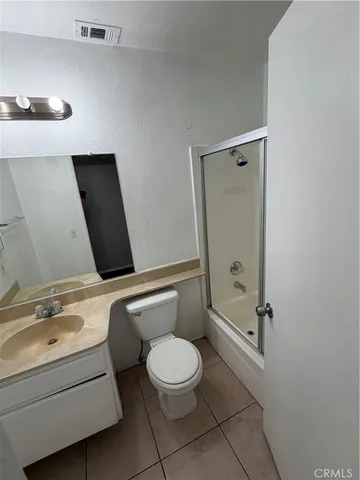 a bathroom with a toilet sink and shower