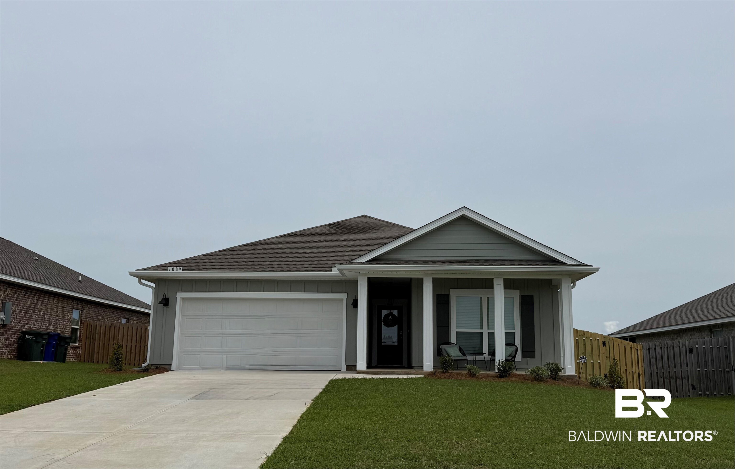 1089 Hayward Loop Foley, AL 36535 - Photo 37 of 37 Single-story residence featuring a covered entry, attached garage, concrete driveway, and manicured landscaping