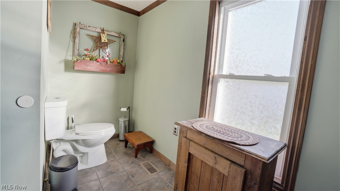 65892 Endley Road Cambridge, OH 43725 - Photo 35 of 50 Bathroom with toilet and crown molding
