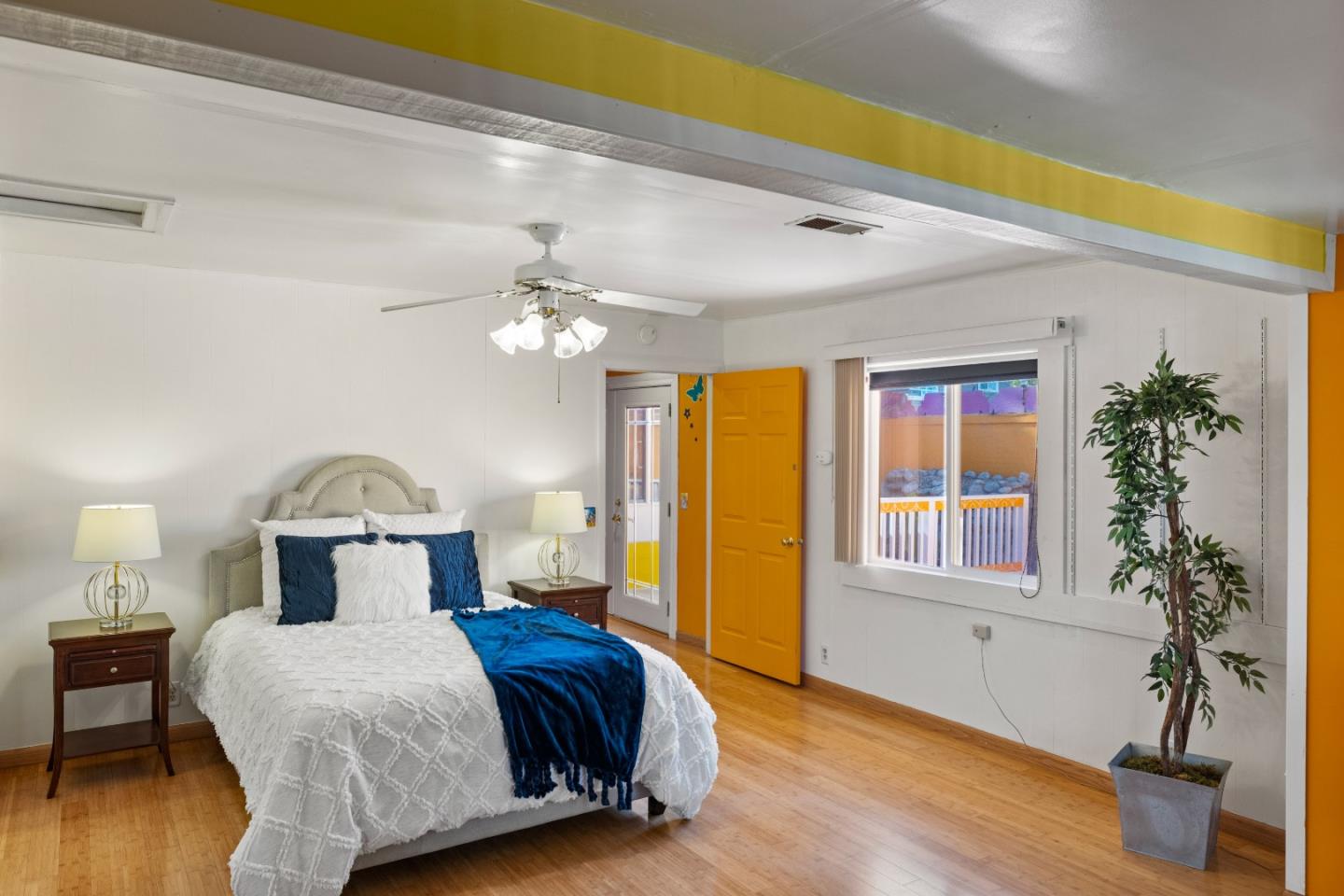 309 9th Street Pacific Grove, CA 93950 - Photo 12 of 36 a bedroom with a bed and wooden floor
