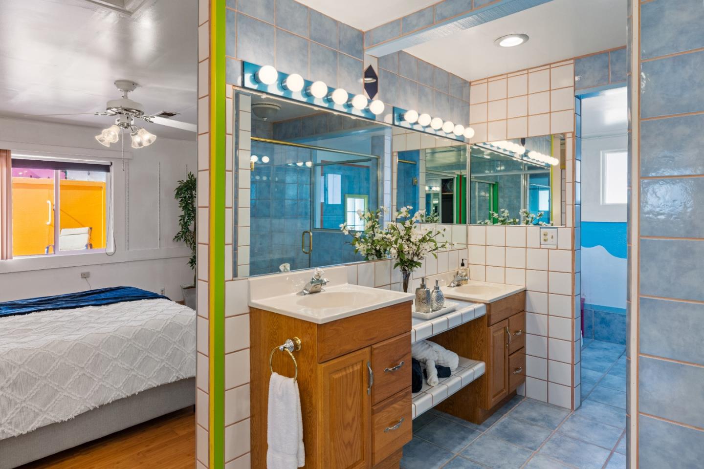 309 9th Street Pacific Grove, CA 93950 - Photo 14 of 36 a bathroom with a sink a faucet a mirror and a shower