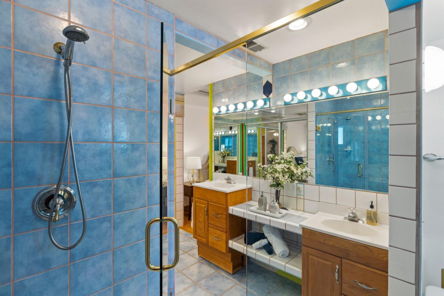 309 9th Street Pacific Grove, CA 93950 - Photo 16 of 36 a bathroom with double vanity and a shower
