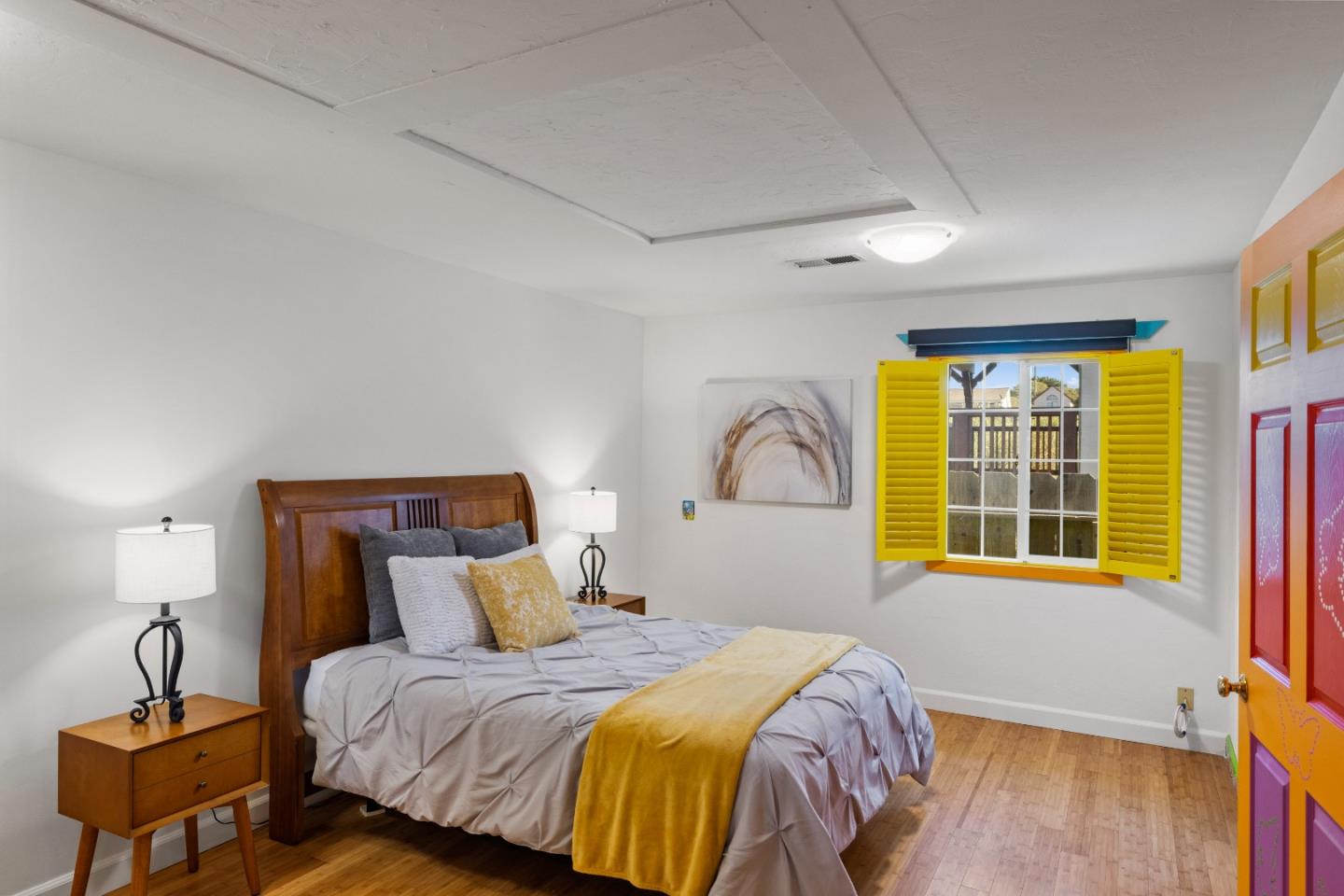 309 9th Street Pacific Grove, CA 93950 - Photo 18 of 36 a bedroom with a bed and wooden floor