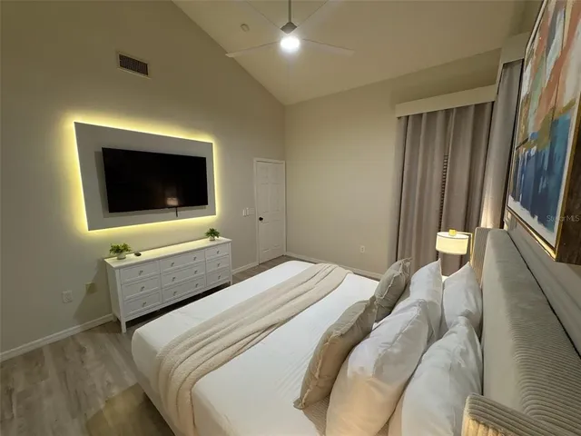 a bedroom with a bed and a flat screen tv