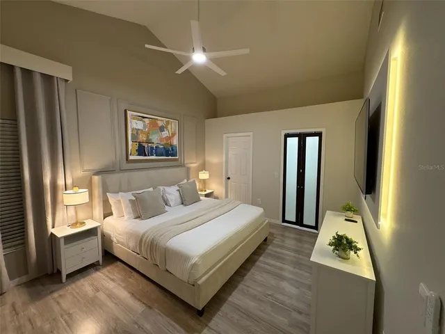 a bedroom with a bed and a large window