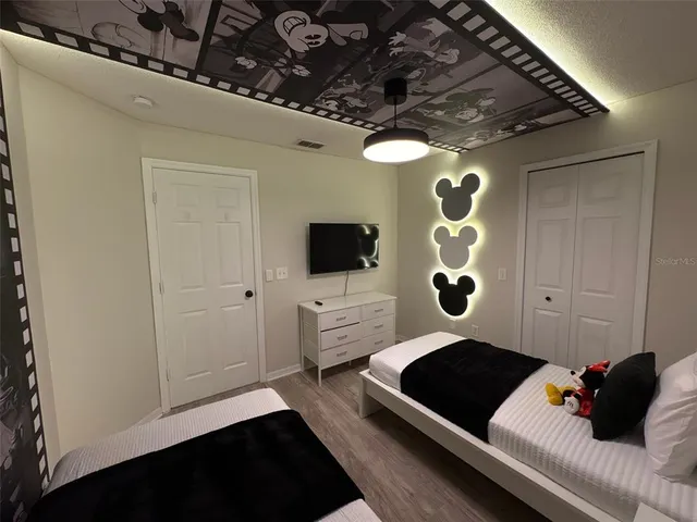 a bedroom with a bed and cabinets