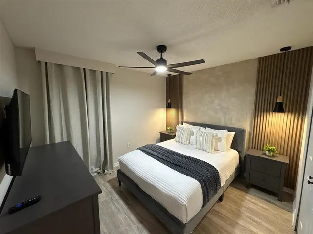 a bedroom with a bed and a flat screen tv