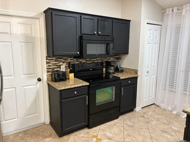 a kitchen with a stove and a microwave