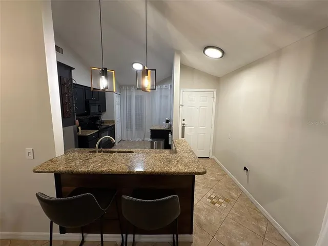 a kitchen with a table chairs and a refrigerator