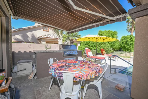 a patio with a table and chairs