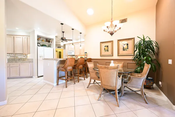 a view of a dining room with furniture and a chandelier