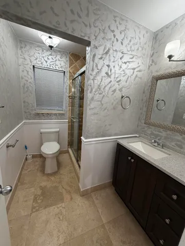 a bathroom with a sink toilet and shower