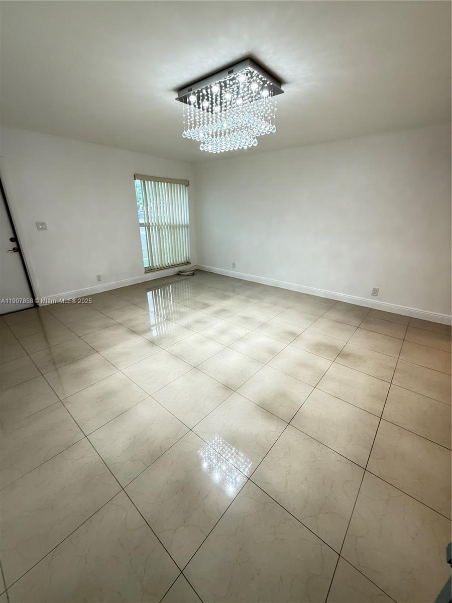 5215 Southwest 40th Avenue, Unit 48 Dania Beach, FL 33314 - Photo 1 of 12 a view of an empty room with a window