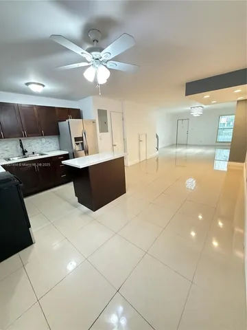 a kitchen with a sink a counter top space and appliances