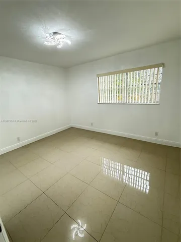 an empty room with a empty space and windows
