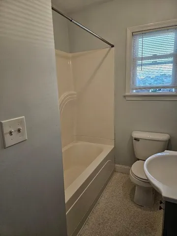 a bathroom with a toilet and a bathtub