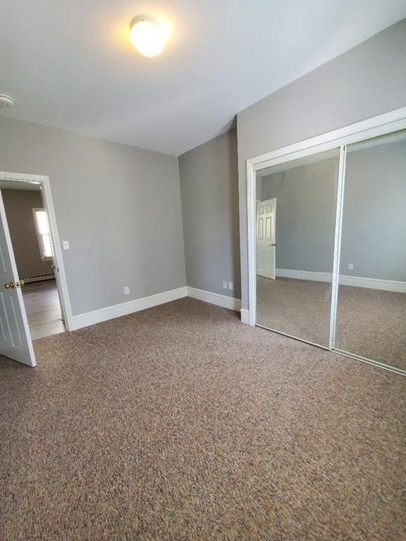 403 Manchester Street, Unit 3 Fall River, MA 02721 - Photo 9 of 15 an empty room with a fireplace